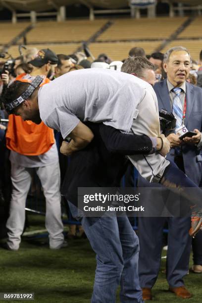 Jose Altuve of the Houston Astros and Hall of Famer Craig Biggio celebrate on the field after the Astros defeated the Los Angeles Dodgers in Game 7...