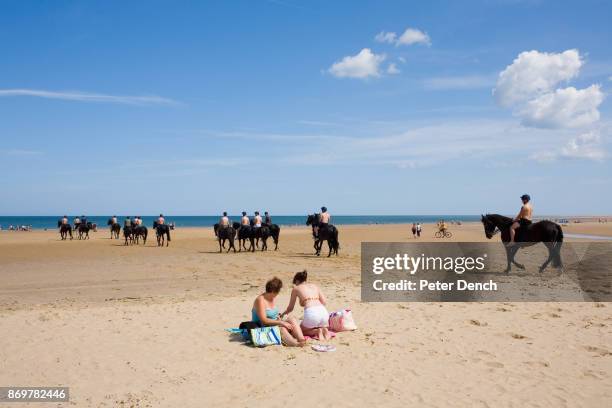 Troopers of the mounted regiment's Blues and Royals squadron enjoy a break from their regular routine at Holkham beach. The Household Cavalry is made...