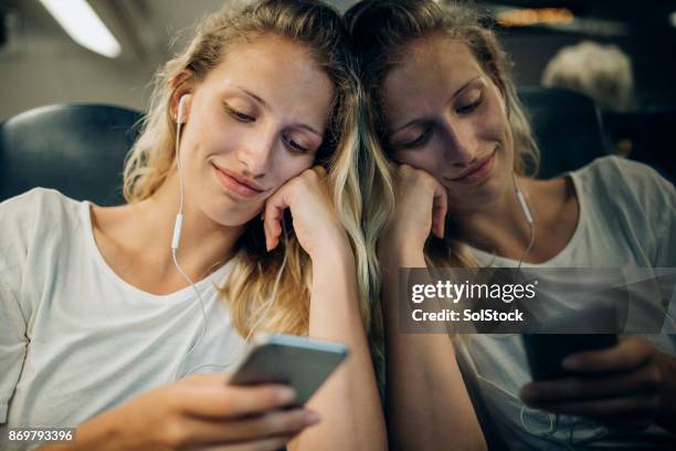 relaxing on the journey home - person looking at phone while smiling australia stock pictures, royalty-free photos & images