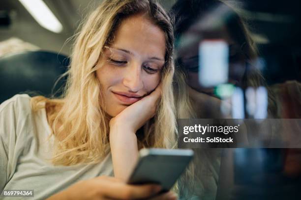 relaxing on the train - smirking stock pictures, royalty-free photos & images