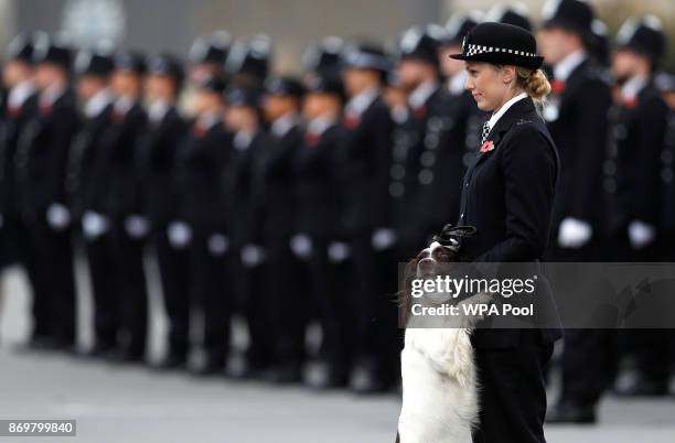 Police officer and her police dog stand to attention as they attend the Metropolitan Police Service Passing Out Parade in Hendon on November 3, 2017...