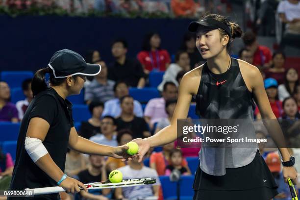 Xinyu Jiang and Qianhui Tang of China talks during the doubles Round Robin match of the WTA Elite Trophy Zhuhai 2017 against Alicja Rosolska of...