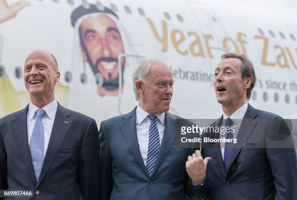 Tim Clark, president of Emirates Airlines, center, gestures as Tom Enders, chief executive officer of Airbus SE, left, and Fabrice Bregier, chief...