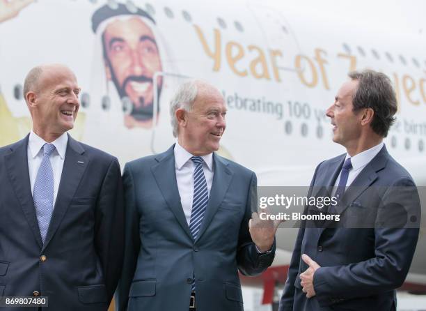 Tim Clark, president of Emirates Airlines, center, gestures as Tom Enders, chief executive officer of Airbus SE, left, and Fabrice Bregier, chief...