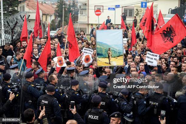 Kosovo Albanians waving Albanian national flags take part in a demonstration in Pristina, on November 3 to protest against the verdict of the...