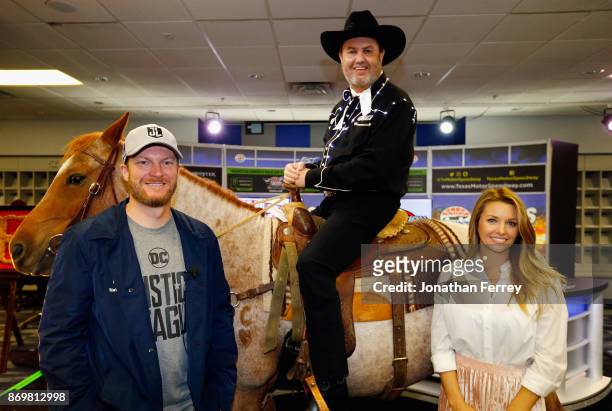 Dale Earnhardt Jr. , driver of the Nationwide/Justice League Chevrolet, and his wife, Amy Earnhardt , pose with Texas Motor Speedway president, Eddie...