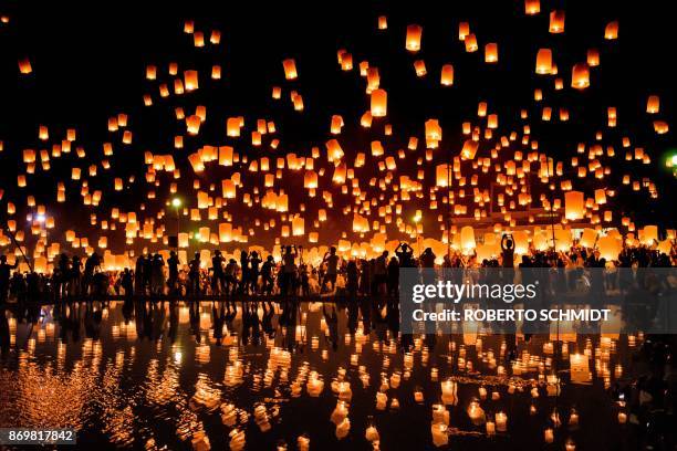 Crowd releases lanterns into the air as they celebrate the Yee Peng festival, also known as the festival of lights, in Chiang Mai on November 3,...