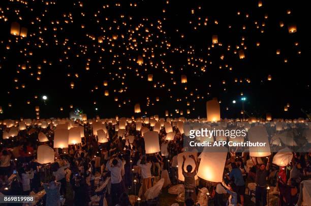 Crowd releases lanterns into the air as they celebrate the Yee Peng festival, also known as the festival of lights, in Chiang Mai on November 3,...