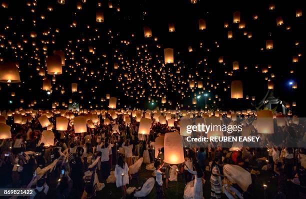 Crowd releases lanterns into the air as they celebrate the Yee Peng festival, also known as the festival of lights, in Chiang Mai on November 3,...