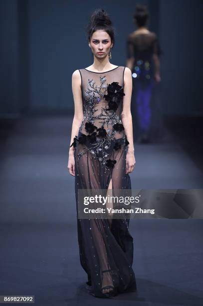 Model showcases designs on the runway at the WANG PEIYI fashion show during the Mercedes-Benz China Fashion Week Spring/Summer 2018 Collection at the...