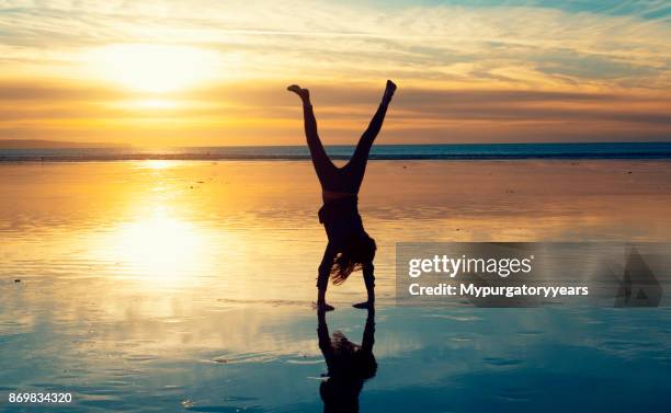 cartwheels on the beach at sunset - cartwheel stock pictures, royalty-free photos & images