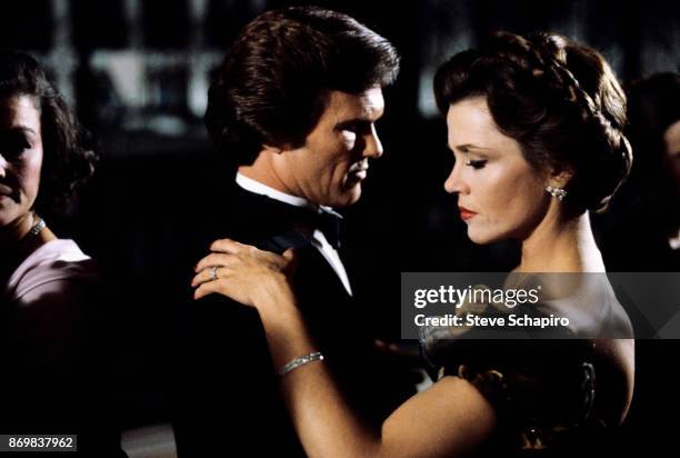 American actors Kris Kristofferson and Jane Fonda dance together in a scene from the film 'Rollover' , New York, New York, 1981.