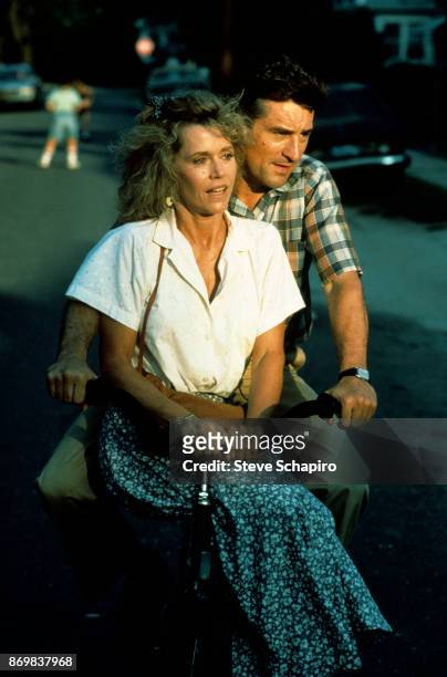 American actors Jane Fonda and Robert De Niro ride a bicycle together in a scene from the film 'Stanley & Iris' , Waterbury, Connecticut, 1990.