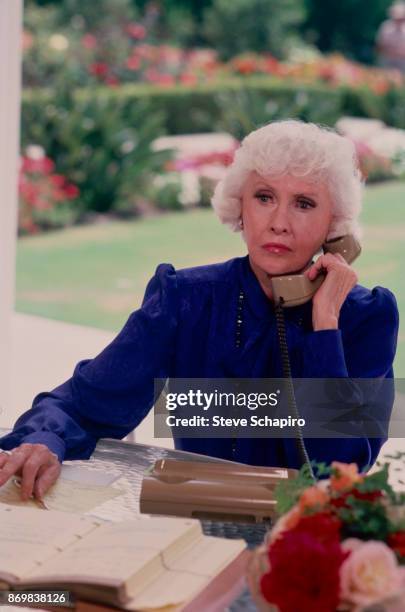 American actress Barbara Stanwyck talks on the telephone in a scene from an episode of the television series 'The Colbys,' Los Angeles, California,...