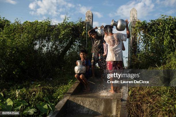 Rakhine Buddhists collect water in the Satroja IDP camp on November 3, 2017 in Sittwe, Myanmar. A segment of the Rakhine Buddhist population was...