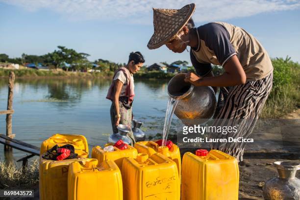 Rakhine Buddhists collect water in the Satroja IDP camp on November 3, 2017 in Sittwe, Myanmar. A segment of the Rakhine Buddhist population was...