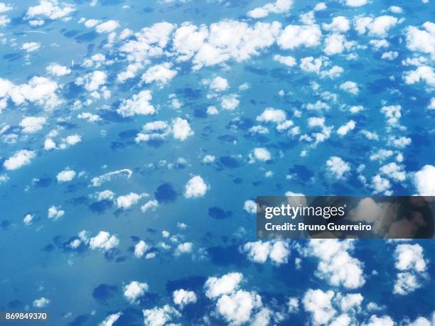 high angle view of sea seen from airplane window - clouds from aircraft point of view stock pictures, royalty-free photos & images
