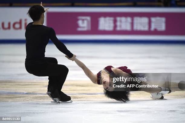 China's ice skaters Sui Wenjing and Han Cong perform in Pairs Short Program during the Cup of China ISU Grand Prix of Figure Skating, in Beijing, on...