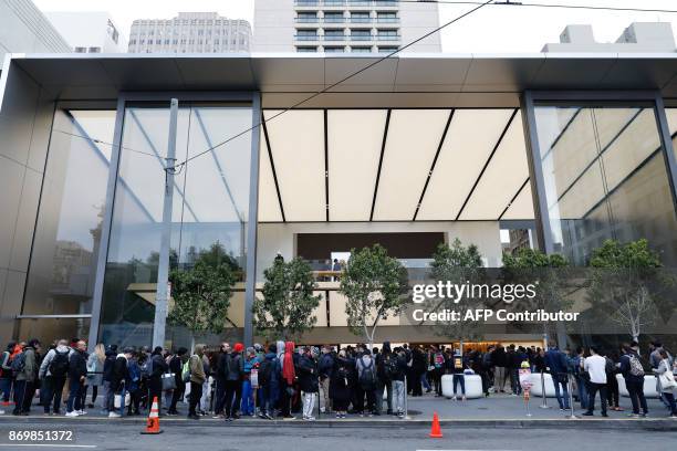 Customers wait in line to purchase the new iPhone X at the Apple Store Union Square on November 3 in San Francisco, California. Apple's flagship...