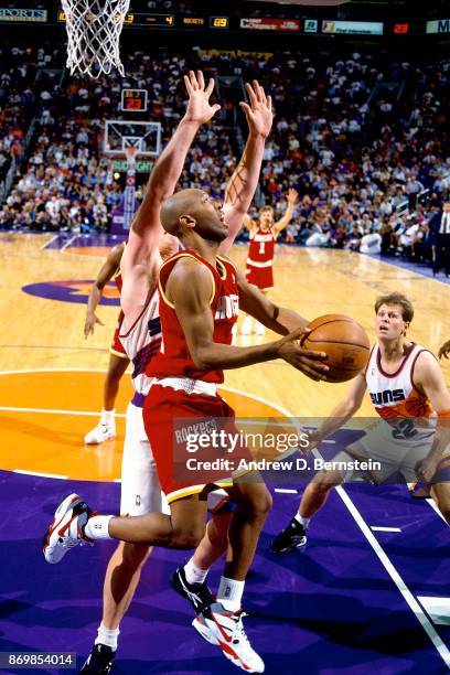 Sam Cassell of the Houston Rockets shoots against Danny Ainge of the Phoenix Suns during Game Six of the Western Conference Semifinals played on May...