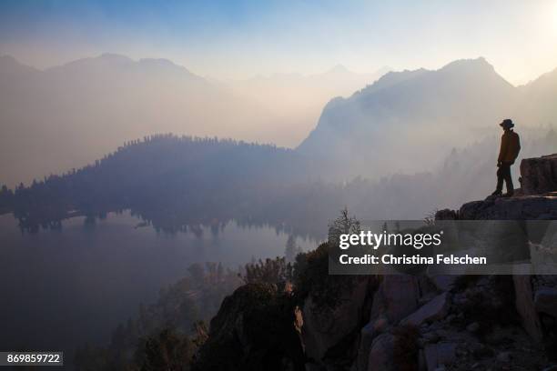 silhouette of a hiker in front of charlotte lake, eastern sierra nevada, california, usa - wilderness stock pictures, royalty-free photos & images
