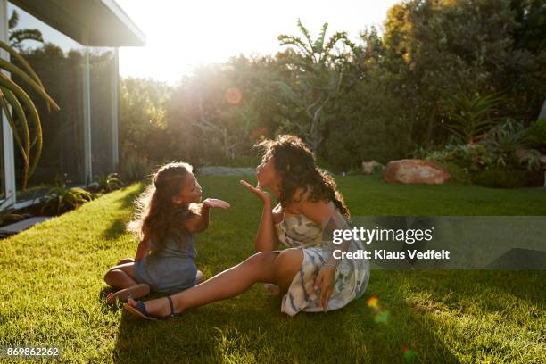 mother and daughter playing and laughing in their garden - mandar um beijo imagens e fotografias de stock