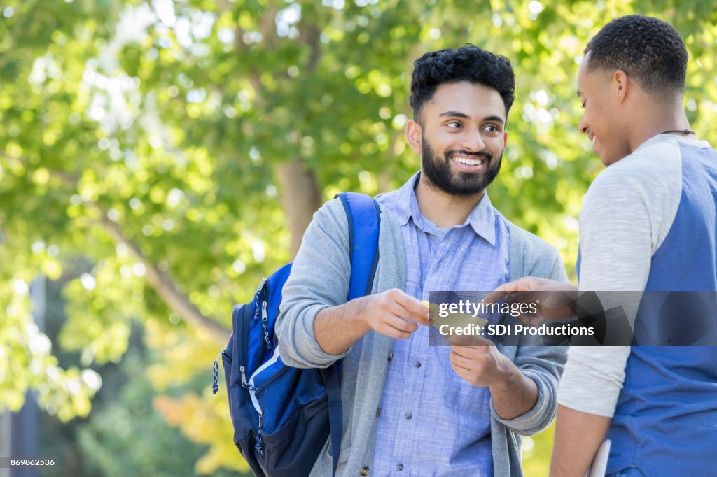 Cheerful young student asks directions on university campus