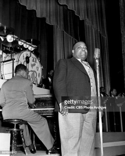 Count Basie and his orchestra has a one week engagement at the Apollo Theater, on 125th Street, New York, NY. In this frame singer Jimmy Rushing...