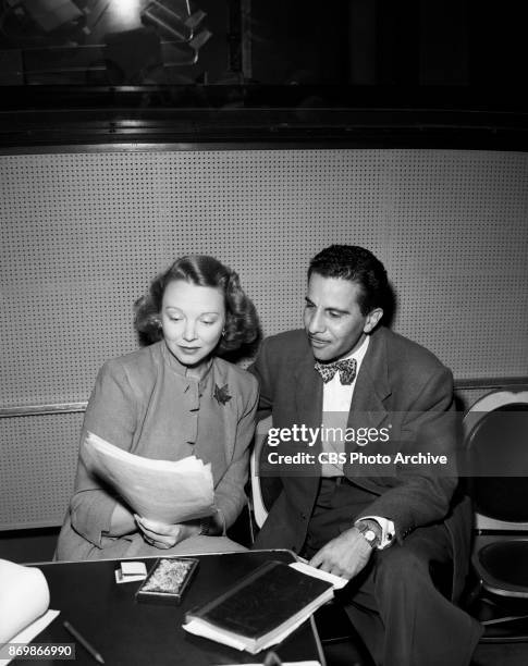 Radios "Make Believe Town" hostess, Virginia Bruce, checks the script with producer-director Ralph Rose. "Make Believe Town," provides stories about...