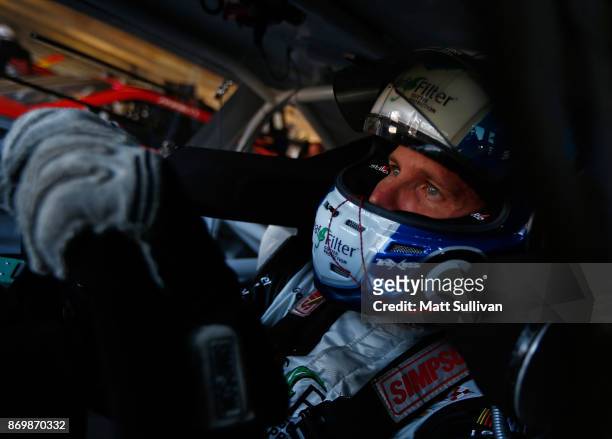 Blake Koch, driver of the LeafFilter Gutter Protection Chevrolet, sits in his car during practice for the NASCAR XFINITY Series O'Reilly Auto Parts...