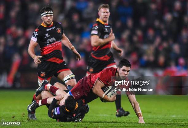 Cork , Ireland - 3 November 2017; Alex Wootton of Munster is tackled by Adam Warren of Dragons during the Guinness PRO14 Round 8 match between...