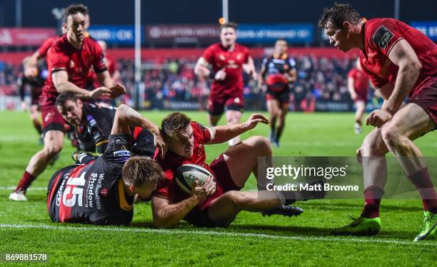 Cork , Ireland - 3 November 2017; Rory Scannell of Munster scores his side's first try despite the efforts of Will Talbot-Davies of Dragons during...