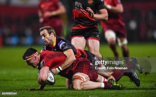 Cork , Ireland - 3 November 2017; Robin Copeland of Munster is tackled by Sarel Pretorius of Dragons during the Guinness PRO14 Round 8 match between...