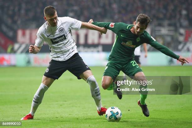 Ante Rebic of Frankfurt is challenged by Fin Bartels of Bremen during the Bundesliga match between Eintracht Frankfurt and SV Werder Bremen at...