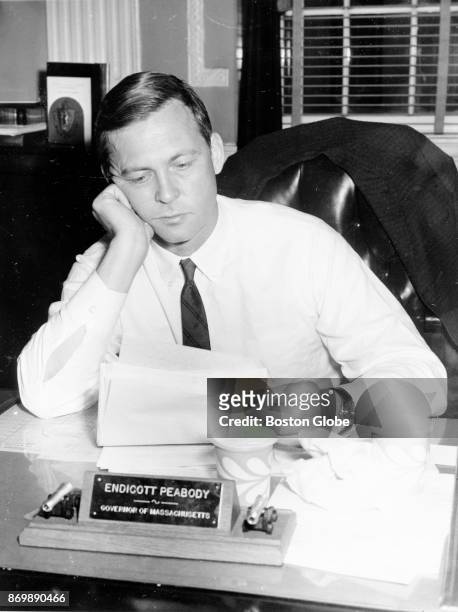 Governor Endicott Peabody works at his desk in the State House in Boston on April 8, 1964.