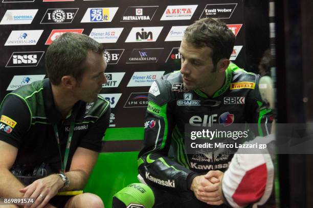 Sylvain Guintoli of France and Kawasaki Puccetti Racing speaks in box with Andrew Pitt of Australia and Kawasaki Puccetti Racing during the race 1 of...