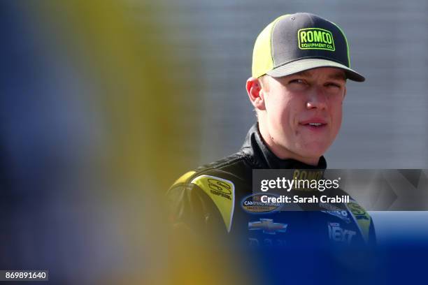 John H. Nemechek, driver of the ROMCO Equipment./Fire Alarm Services Chevrolet, stands on the grid during Salute To Veterans Qualifying Days Fueled...