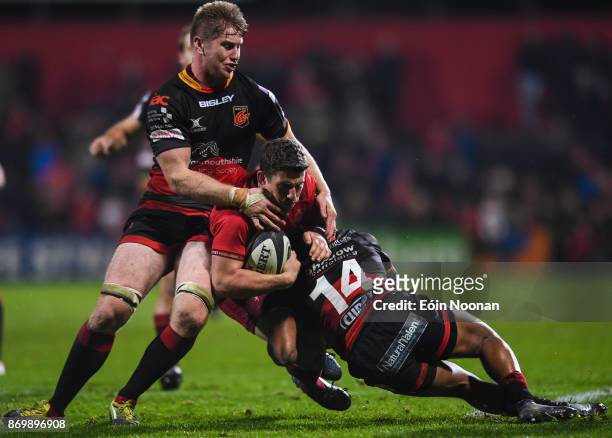 Cork , Ireland - 3 November 2017; Ian Keatley of Munster is tackled by Aaron Wainwright, left and Ashton Hewitt of Dragons during the Guinness PRO14...