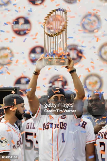 Carlos Correa of the Houston Astros lifts the World Series Trophy during the Houston Astros Victory Parade on November 3, 2017 in Houston, Texas. The...