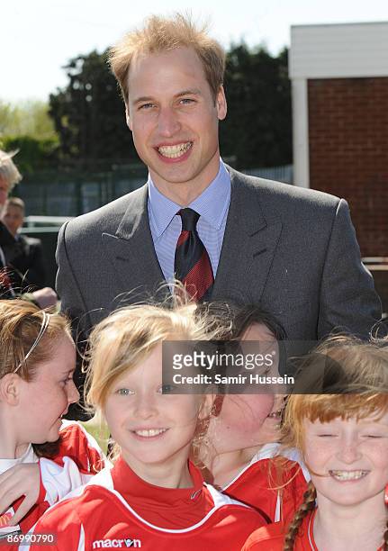 Prince William, President of The Football Association poses with young players as he visits Kingshurst Sporting FC on May 11, 2009 in Kingshurst,...