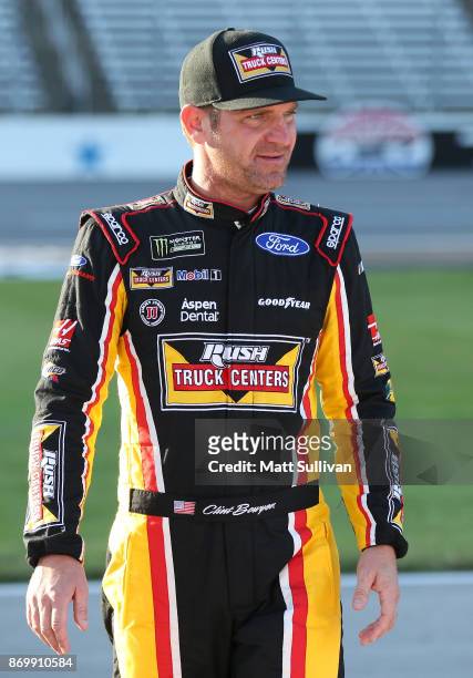 Clint Bowyer, driver of the Rush Truck Centers/Mobil Delvac 1 Ford, stands by his car during Salute To Veterans Qualifying Days Fueled by Texas...