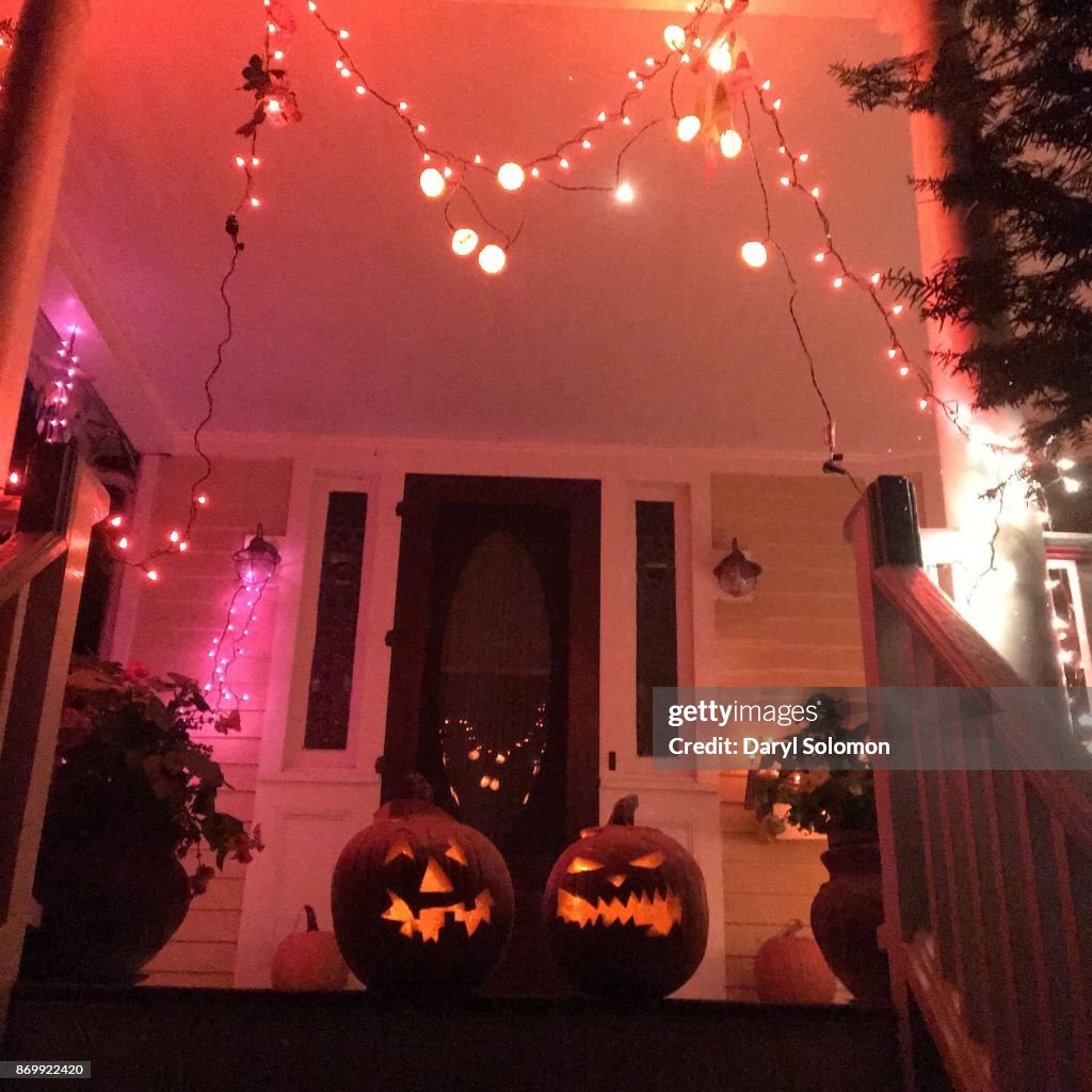Carved pumpkins on a front porch