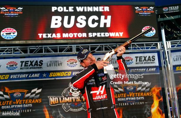 Kurt Busch, driver of the Haas Automation/Monster Energy Ford, poses with the pole award rifle after qualifying in the pole position for the Monster...