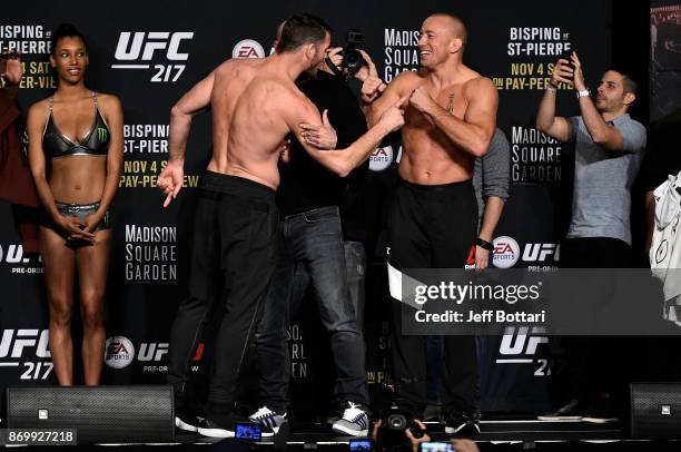 Michael Bisping of England and Georges St-Pierre of Canada face off during the UFC 217 weigh-in inside Madison Square Garden on November 3, 2017 in...