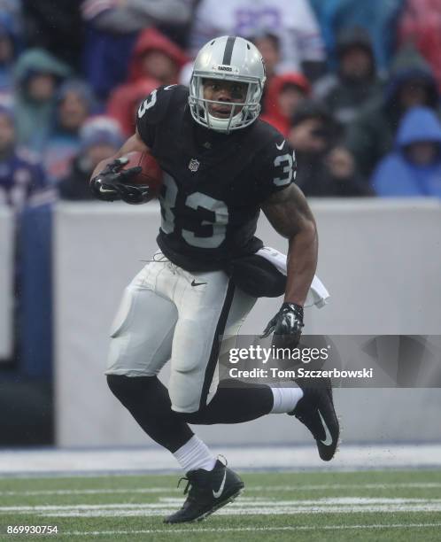 DeAndre Washington of the Oakland Raiders carries the ball during NFL game action against the Buffalo Bills at New Era Field on October 29, 2017 in...