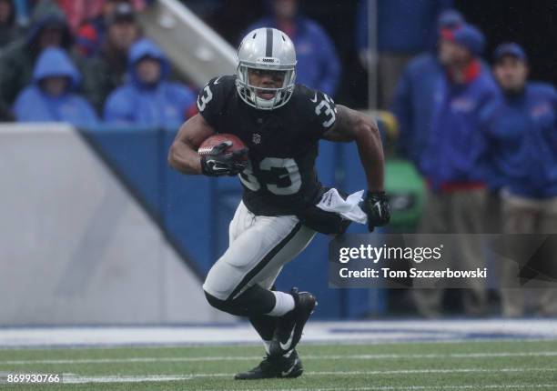 DeAndre Washington of the Oakland Raiders carries the ball during NFL game action against the Buffalo Bills at New Era Field on October 29, 2017 in...