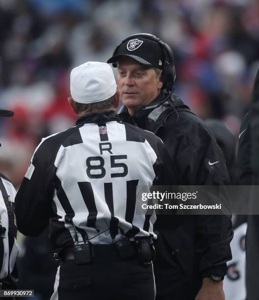 Head coach Jack Del Rio of the Oakland Raiders questions referee Ed Hochuli during NFL game action against the Buffalo Bills at New Era Field on...