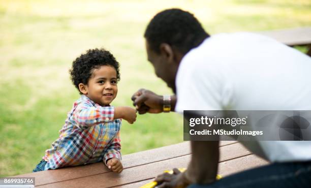 father-son fist bump. - child fist bump stock pictures, royalty-free photos & images