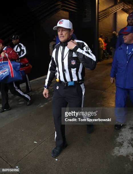 Referee Ed Hochuli walks out onto the field of play through the tunnel before the start of the Buffalo Bills NFL game against the Oakland Raiders at...