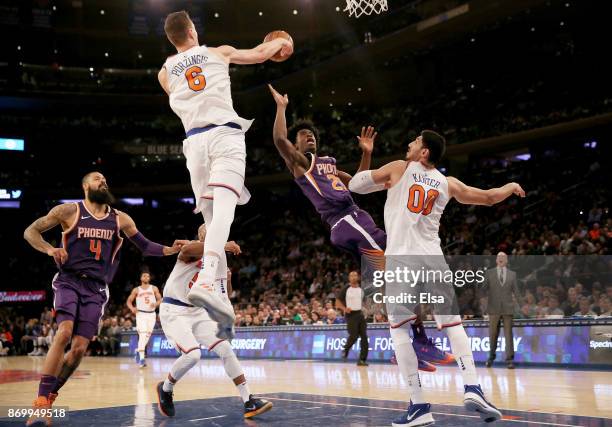 Kristaps Porzingis of the New York Knicks blocks a shot by Josh Jackson of the Phoenix Suns after Jackson stole the ball from Porzingis in the...